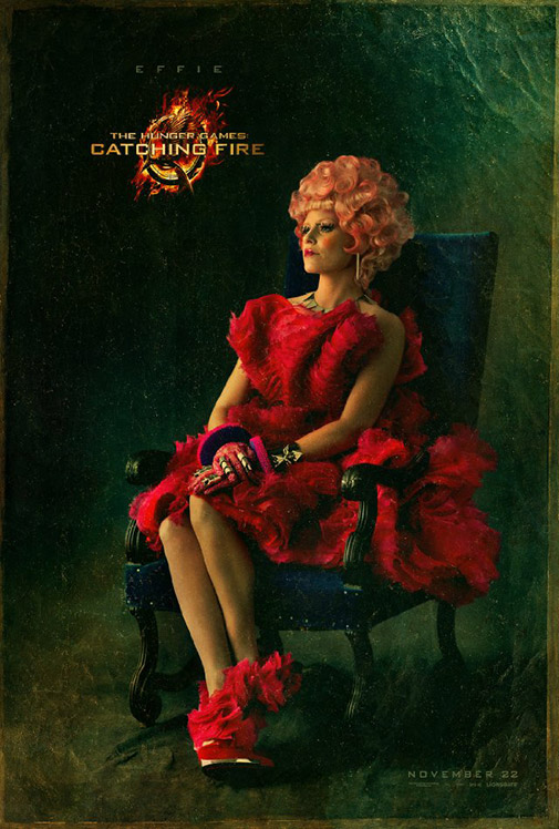 Effie in a fluffy red dress and pink wig