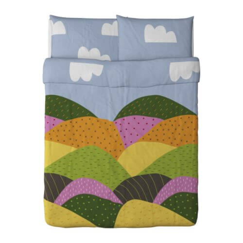 duvet cover with quilt-like illustration of rolling hills and clouds in the sky