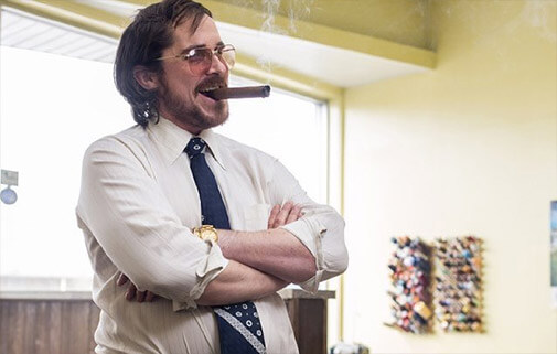 Christian Bale smoking a cigar