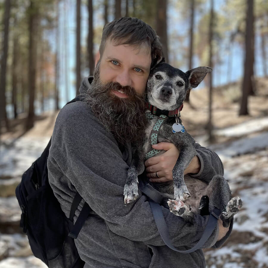 Clay holding Boomer in the snowy forest