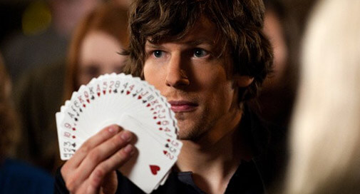 Jesse Eisenberg holding a fanned deck of cards