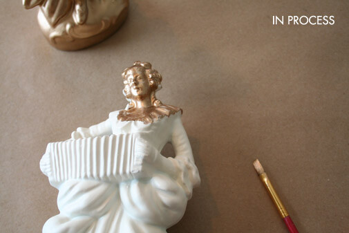 the woman figurine partially painted with liquid gold leaf