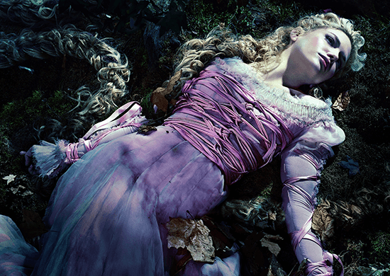 Rapunzel laying on the dirt in a purple dress