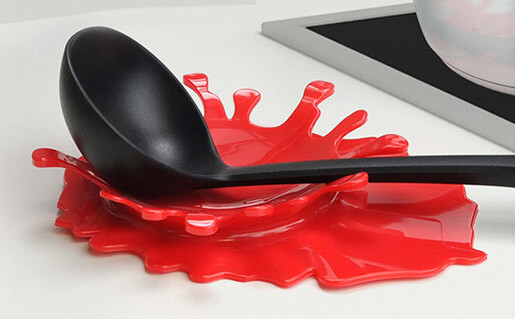 a spoon rest that resembles a splatter of tomato sauce