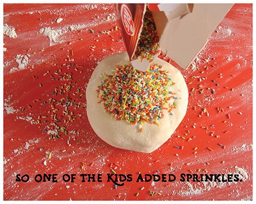 pouring a box of rainbow sprinkles on the dough ball: “So one of the kids added sprinkles.”