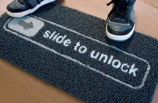 doormat that says “Slide to unlock” like an iPhone