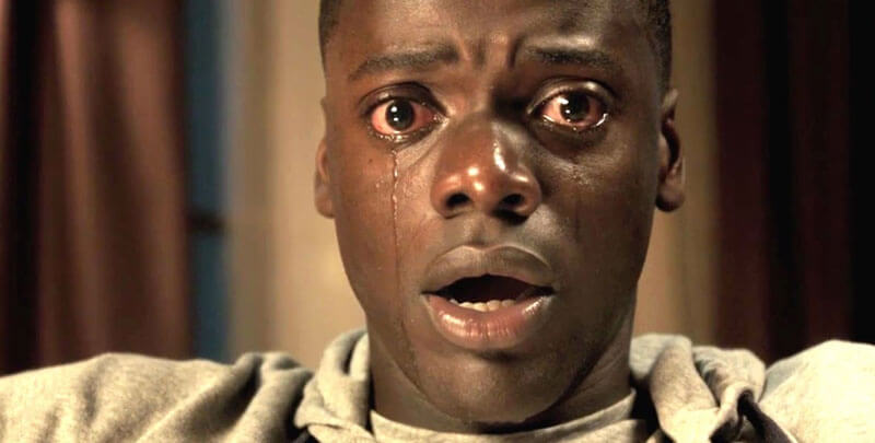 Daniel Kaluuya sits with eyes wide and tears streaming down his face