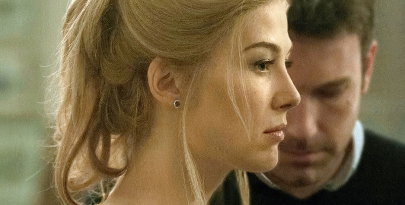 a profile of Amy with her husband Nick in the background
