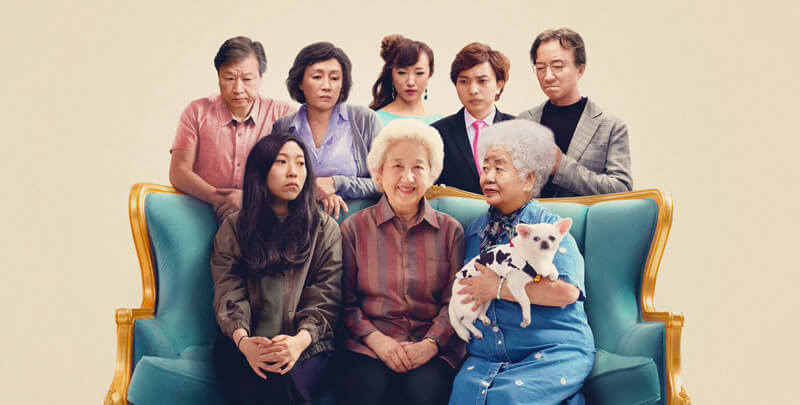 a Chinese family on a couch, surrounding the grandmother