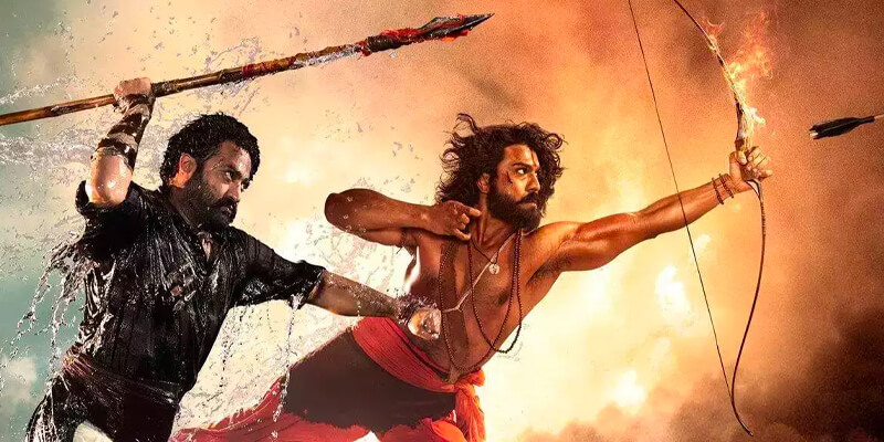 N. T. Rama Rao Jr. and Ram Charan leaping forward with spear and bow and arrow