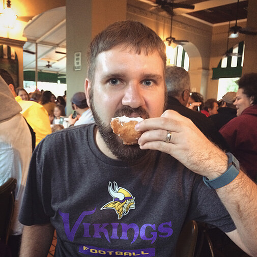 Clay eating a beignet
