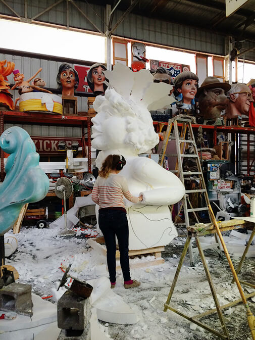 sculptor working on a giant styrofoam figure