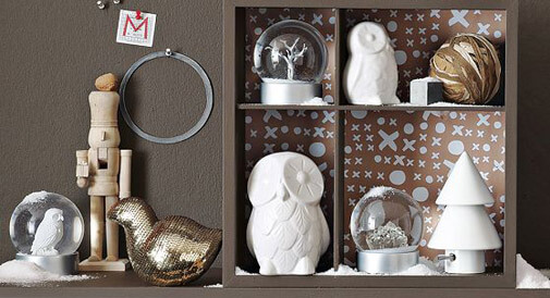 display of Christmas objects including white ceramic owls