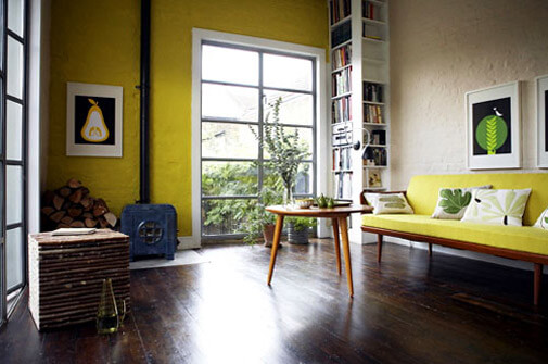 living room with one wall painted bright yellow