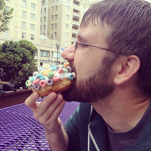 Clay eating a Froot Loops doughnut