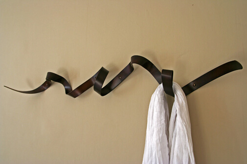 coat hanger that looksl ike a windy, curled piece of ribbon