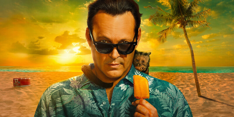 Vince Vaughn in sunglasses and a Hawaiian shirt feeding a monkey a popsicle