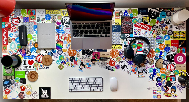 top view of a white desk almost completely covered in stickers