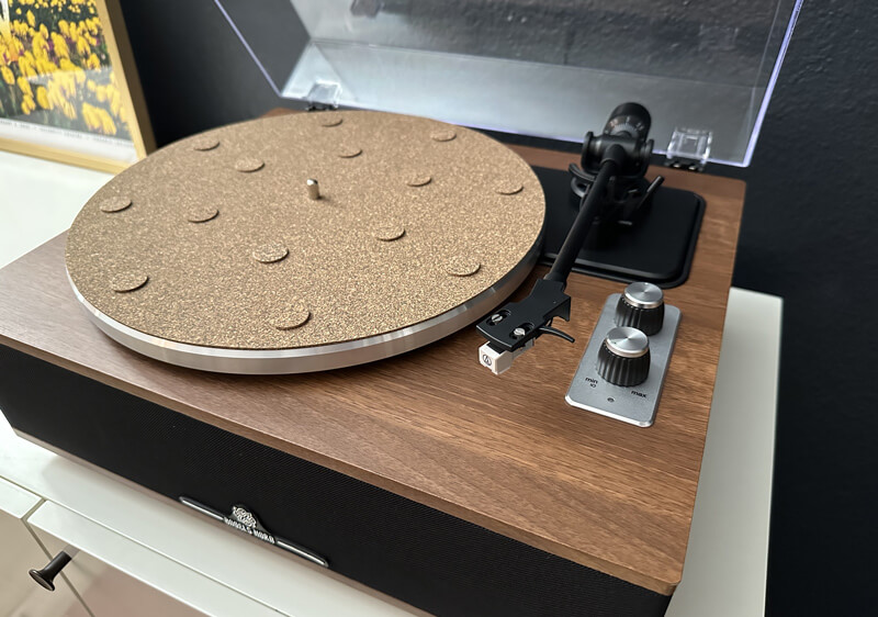 woodgrain turntable with built in black speakers and clear plastic lid