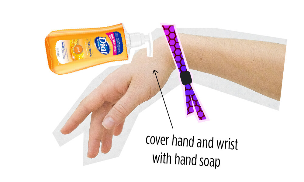 wristband-wearing hand with a dial soap pump